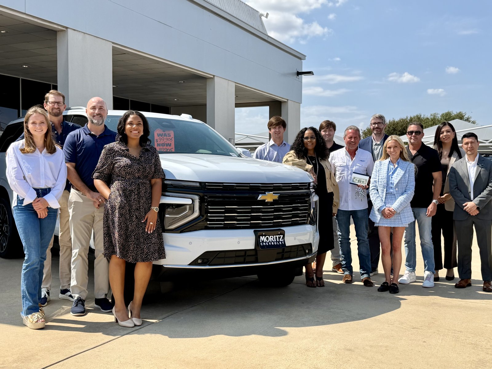 Hiley family and team members with a Chevrolet at the Camp Bowie West dealership